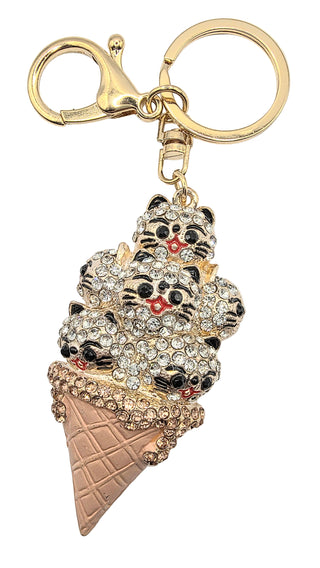 Keychain shaped like a ice cream cone with cat faces on a white background